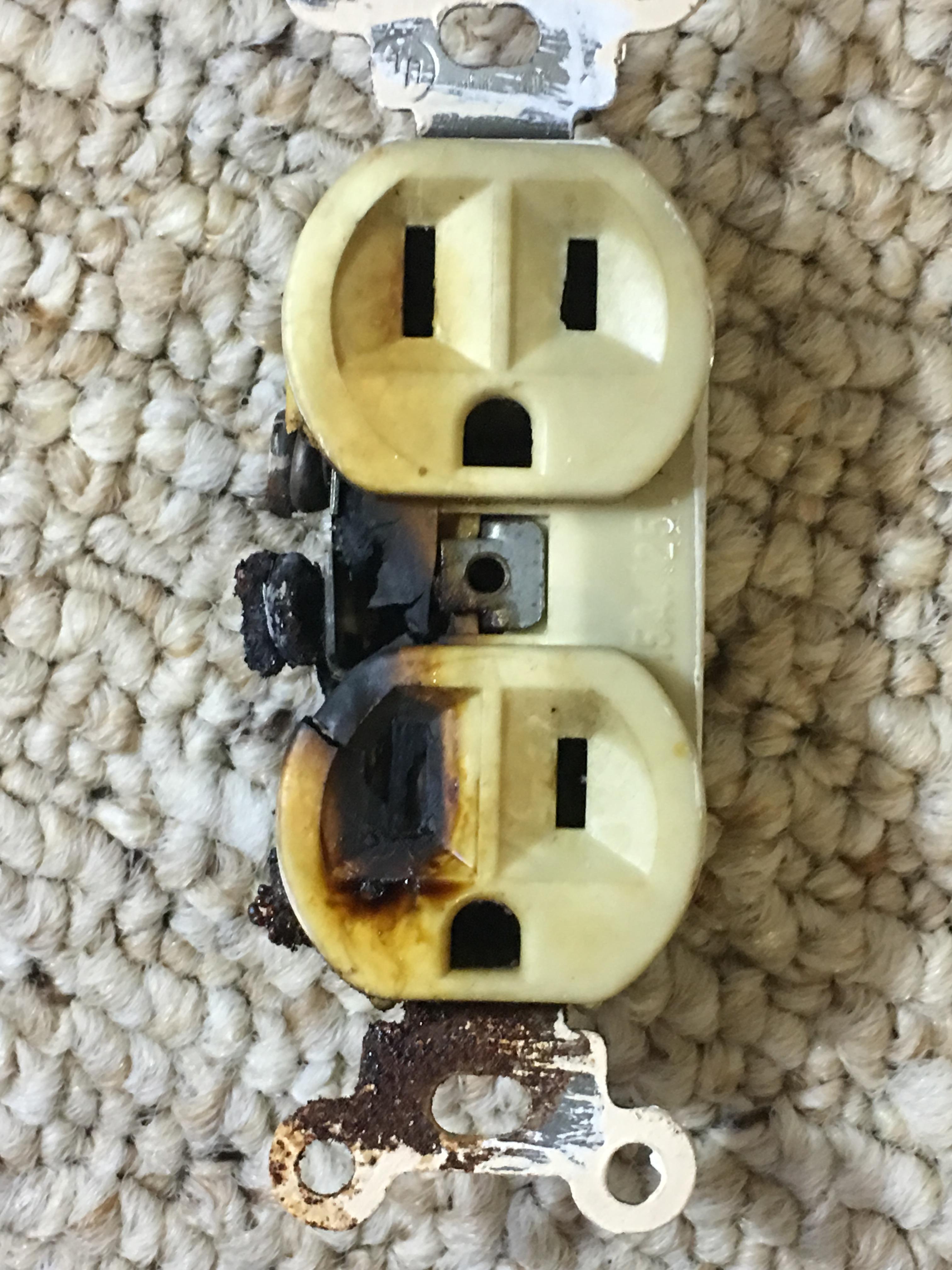 Atlanta electrician repairs burned outlet